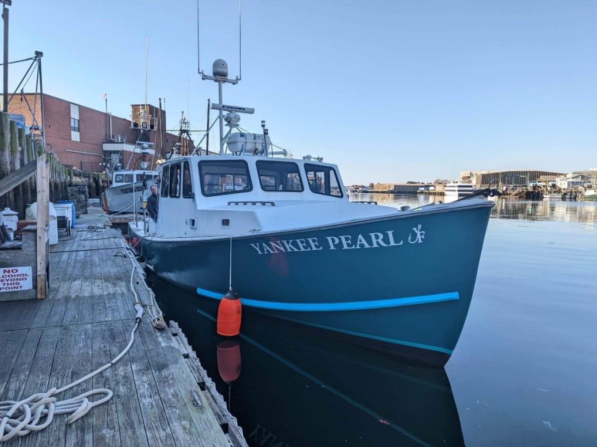 a boat is docked next to a body of water